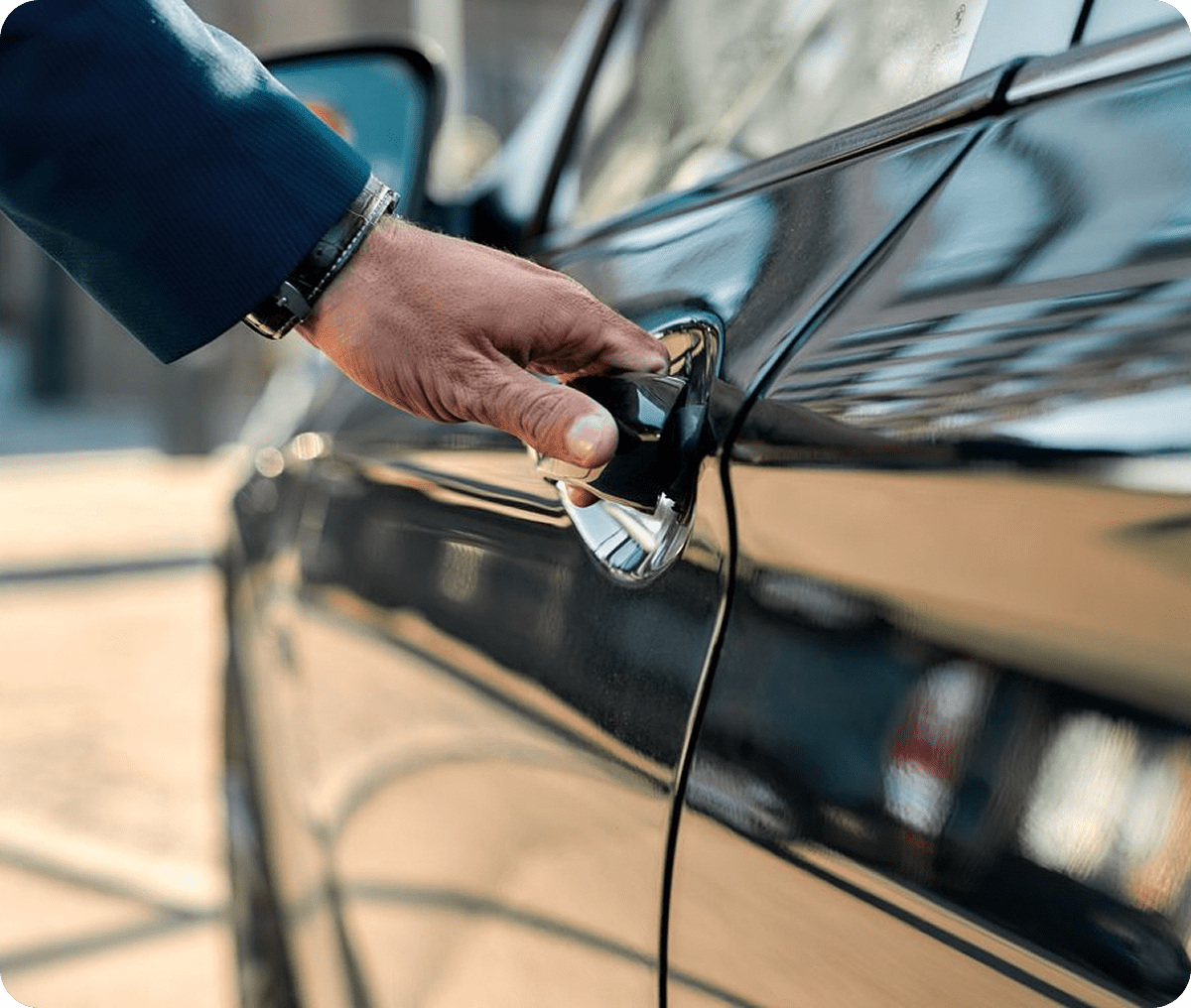 Close-up of hand on car door handle