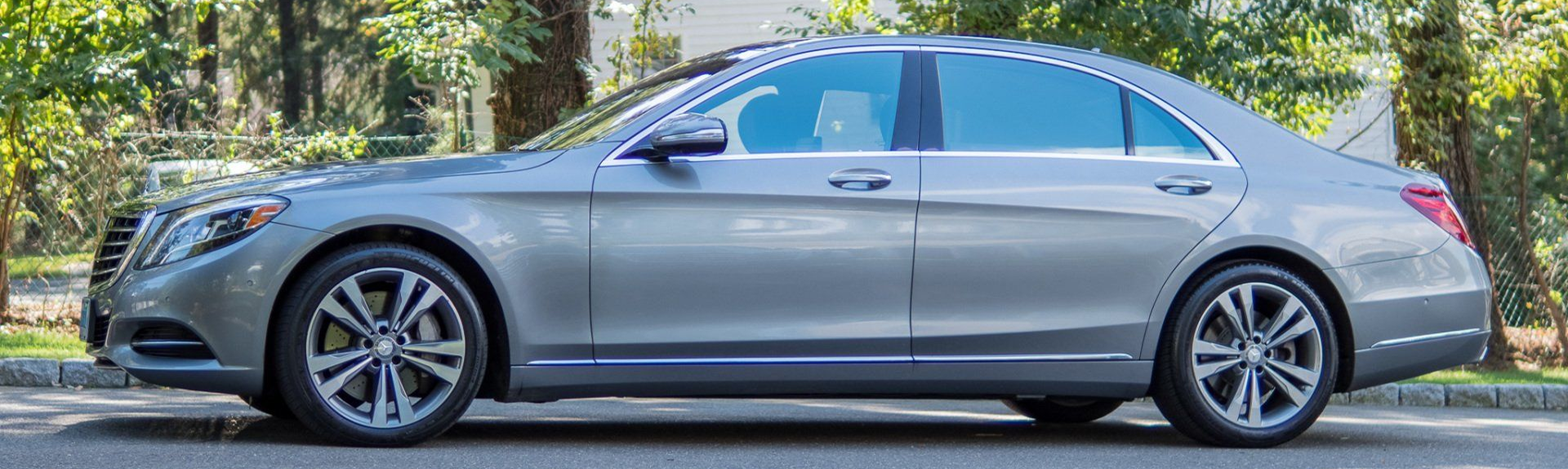 Silver luxury sedan parked on a street.