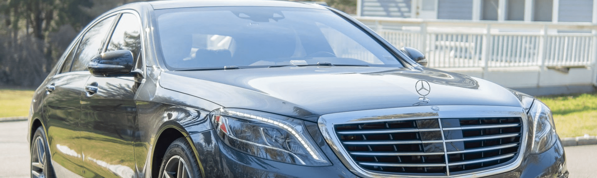 Black luxury sedan parked on street.